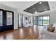 Spacious living room with hardwood floors, neutral tones, and sliding glass doors to the lanai at 5863 Cavano Dr, Sarasota, FL 34231
