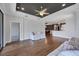 Open-concept living room with hardwood floors, white sofas, and views into the dining and kitchen areas at 5863 Cavano Dr, Sarasota, FL 34231