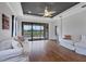 Bright living room features dark ceilings, ceiling fan and sliding door with backyard views at 5863 Cavano Dr, Sarasota, FL 34231
