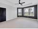 Spacious main bedroom features a ceiling fan, tray ceiling, and large window views at 5863 Cavano Dr, Sarasota, FL 34231