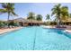 Community pool with sun loungers and tropical landscaping, creating a resort-style setting at 5863 Cavano Dr, Sarasota, FL 34231
