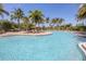 Relax in this large community pool surrounded by mature palm trees and plenty of lounge seating at 5863 Cavano Dr, Sarasota, FL 34231