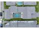 Aerial view of a home featuring a private outdoor pool, patio area, and tropical landscaping at 6028 Red Mangrove Ln, Bradenton, FL 34210
