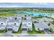 Scenic aerial view of Aqua homes highlighting the neighborhood lagoon and manicured landscaping at 6028 Red Mangrove Ln, Bradenton, FL 34210