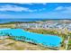 Great aerial view of a pristine blue lagoon and beach community, ideal for recreation and relaxation at 6028 Red Mangrove Ln, Bradenton, FL 34210