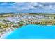 Stunning aerial view of a bright blue lagoon surrounded by palm trees and rows of beautiful single-Gathering homes in a Primary-planned community at 6028 Red Mangrove Ln, Bradenton, FL 34210