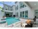 A lovely backyard features a pool, white walls, an outdoor seating area and shade at 6028 Red Mangrove Ln, Bradenton, FL 34210