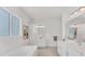 Bright bathroom with dual vanities, soaking tub, and modern finishes at 6028 Red Mangrove Ln, Bradenton, FL 34210