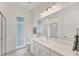 Bathroom with modern fixtures, large mirror, and glass shower enclosure at 6028 Red Mangrove Ln, Bradenton, FL 34210