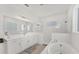Bright bathroom featuring dual sinks, a soaking tub, and a glass-enclosed shower at 6028 Red Mangrove Ln, Bradenton, FL 34210