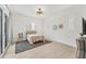 Bedroom with a woven ceiling fan, minimalist decor, and patio access at 6028 Red Mangrove Ln, Bradenton, FL 34210