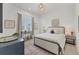 This bedroom is bathed in natural light with a window, chic furniture and calm decor at 6028 Red Mangrove Ln, Bradenton, FL 34210
