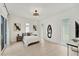 Bright bedroom featuring light wood floors, modern lighting, and contemporary decor at 6028 Red Mangrove Ln, Bradenton, FL 34210