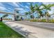 Welcoming gated entrance to Aqua community, showcasing well-manicured landscaping and design at 6028 Red Mangrove Ln, Bradenton, FL 34210