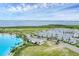 Waterfront community featuring white modern style homes, palm trees, and a lagoon at 6028 Red Mangrove Ln, Bradenton, FL 34210