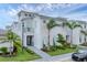 Beautiful three-story home with modern architectural details and lush tropical landscaping at 6028 Red Mangrove Ln, Bradenton, FL 34210