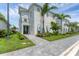 Modern home featuring a paver walkway, lush landscaping, and a covered front entry at 6028 Red Mangrove Ln, Bradenton, FL 34210