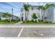 Well-manicured lawn with tropical landscaping and a paver walkway lead to the front door of this modern home at 6028 Red Mangrove Ln, Bradenton, FL 34210