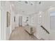 Hallway with art, modern light fixture, neutral color scheme, and views of the home's upper level at 6028 Red Mangrove Ln, Bradenton, FL 34210