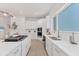 Bright kitchen with white cabinetry, stainless steel appliances, and an island with a gas cooktop at 6028 Red Mangrove Ln, Bradenton, FL 34210