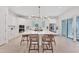 Bright kitchen with white cabinets, a large island, and access to outdoor pool area at 6028 Red Mangrove Ln, Bradenton, FL 34210