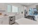 Modern kitchen with white countertops, stainless steel appliances, and backyard views at 6028 Red Mangrove Ln, Bradenton, FL 34210