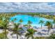Picturesque lagoon view with shaded seating, palm trees, and white sandy beaches for community enjoyment at 6028 Red Mangrove Ln, Bradenton, FL 34210