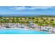 Picturesque view of a white-sand beach with lounge chairs next to the bright turquoise lagoon at 6028 Red Mangrove Ln, Bradenton, FL 34210