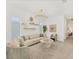 Inviting living room with a sectional sofa, modern light fixture, and decorative shelving at 6028 Red Mangrove Ln, Bradenton, FL 34210