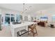 Open-concept kitchen and living room with recessed lighting, sleek furnishings, and sliding doors to the pool at 6028 Red Mangrove Ln, Bradenton, FL 34210