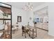 Bright home office featuring a modern desk, comfortable seating, contemporary light fixture, and shelving at 6028 Red Mangrove Ln, Bradenton, FL 34210