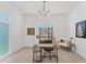 Bright home office featuring a modern desk, comfortable seating, and a contemporary light fixture at 6028 Red Mangrove Ln, Bradenton, FL 34210
