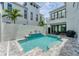 Modern home featuring an outdoor private pool with waterfall feature, stylish patio, and outdoor grilling area at 6028 Red Mangrove Ln, Bradenton, FL 34210