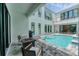 This home features a private pool with a waterfall feature, outdoor seating, and a grilling area at 6028 Red Mangrove Ln, Bradenton, FL 34210