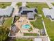 Aerial view of the property showcasing backyard pool, landscaped yard, and solar panels at 6178 Coliseum Blvd, Port Charlotte, FL 33981