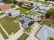 Beautiful aerial view showcasing a pool and landscaping, complementing the gray-roofed home with solar panels at 6178 Coliseum Blvd, Port Charlotte, FL 33981