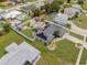 Aerial view of the property showcasing lush landscaping, pool, and outdoor living spaces at 6178 Coliseum Blvd, Port Charlotte, FL 33981