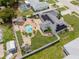 Aerial view of a home and outdoor space featuring solar panels and pool at 6178 Coliseum Blvd, Port Charlotte, FL 33981