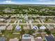 Wide aerial shot of a residential neighborhood, with lush greenery and homes with pools at 6178 Coliseum Blvd, Port Charlotte, FL 33981