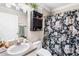Cozy bathroom with floral shower curtain, vanity, mirror and cabinet at 6178 Coliseum Blvd, Port Charlotte, FL 33981