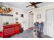 Charming bedroom featuring car decor, a ceiling fan, and storage options at 6178 Coliseum Blvd, Port Charlotte, FL 33981