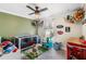 Cute bedroom featuring a crib, plush toys, car decor and a ceiling fan at 6178 Coliseum Blvd, Port Charlotte, FL 33981