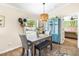 Dining area features natural light, chandelier and gray table set with bench seating at 6178 Coliseum Blvd, Port Charlotte, FL 33981