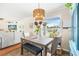 Dining area features natural light, chandelier and gray table set with bench seating at 6178 Coliseum Blvd, Port Charlotte, FL 33981