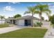 Exterior view of home featuring well-manicured lawn with an attached garage at 6178 Coliseum Blvd, Port Charlotte, FL 33981