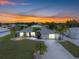 Well-maintained home exterior with lush lawn, mature palm trees, and an inviting driveway at 6178 Coliseum Blvd, Port Charlotte, FL 33981