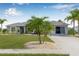 Charming one-story home with a well-manicured lawn and tropical landscaping at 6178 Coliseum Blvd, Port Charlotte, FL 33981