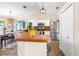 Open-concept kitchen with bar seating, stainless steel appliances, and a clear view of the dining area at 6178 Coliseum Blvd, Port Charlotte, FL 33981