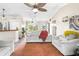 Bright living room with neutral furniture, ceiling fan, and front door view at 6178 Coliseum Blvd, Port Charlotte, FL 33981
