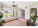 Cozy bonus room with a large window, ceiling fan, and a stylish purple door leading to the home's exterior at 6178 Coliseum Blvd, Port Charlotte, FL 33981